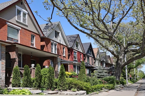 Tree lined street with suburban brick houses